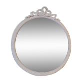 Miroir rond en bois sculpté avec en haut un ruban formant un noeud coloris crème