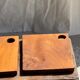 Small rectangular teak monoxyle cutting board with a circular handle.