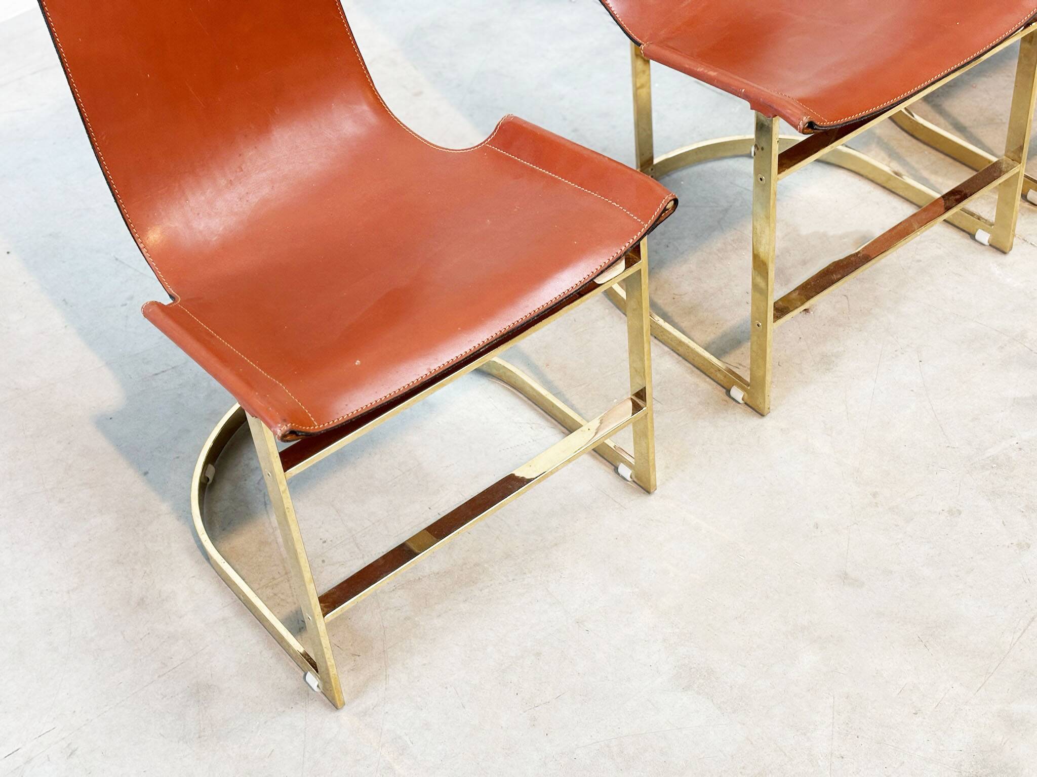 Set of four leather and brass Italian dining chairs