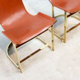 Set of four leather and brass Italian dining chairs