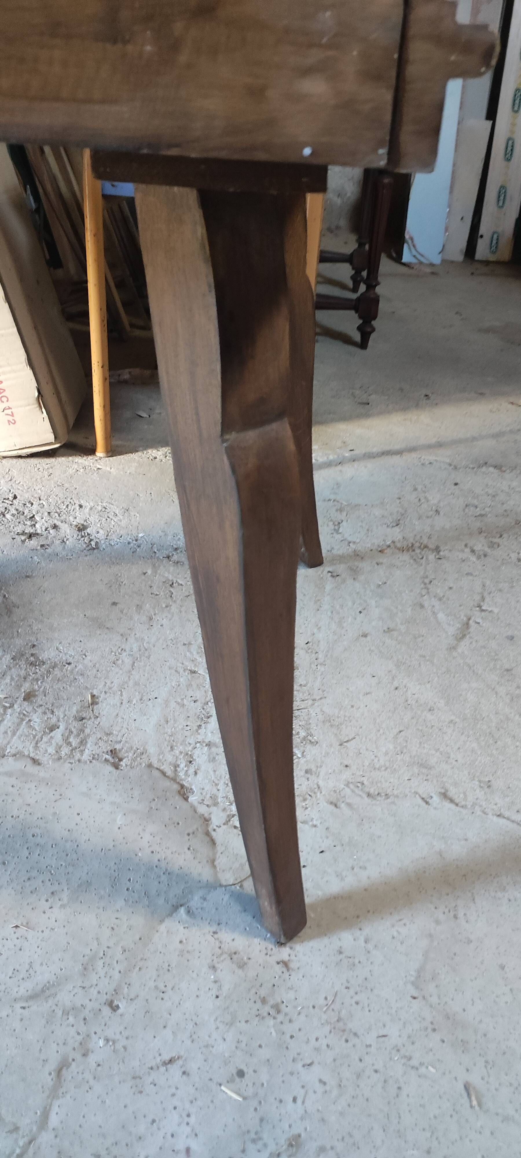 Solid oak dining table with integrated extensions.
