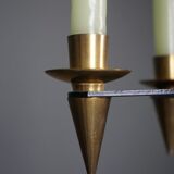 Candle holder in black metal and brass