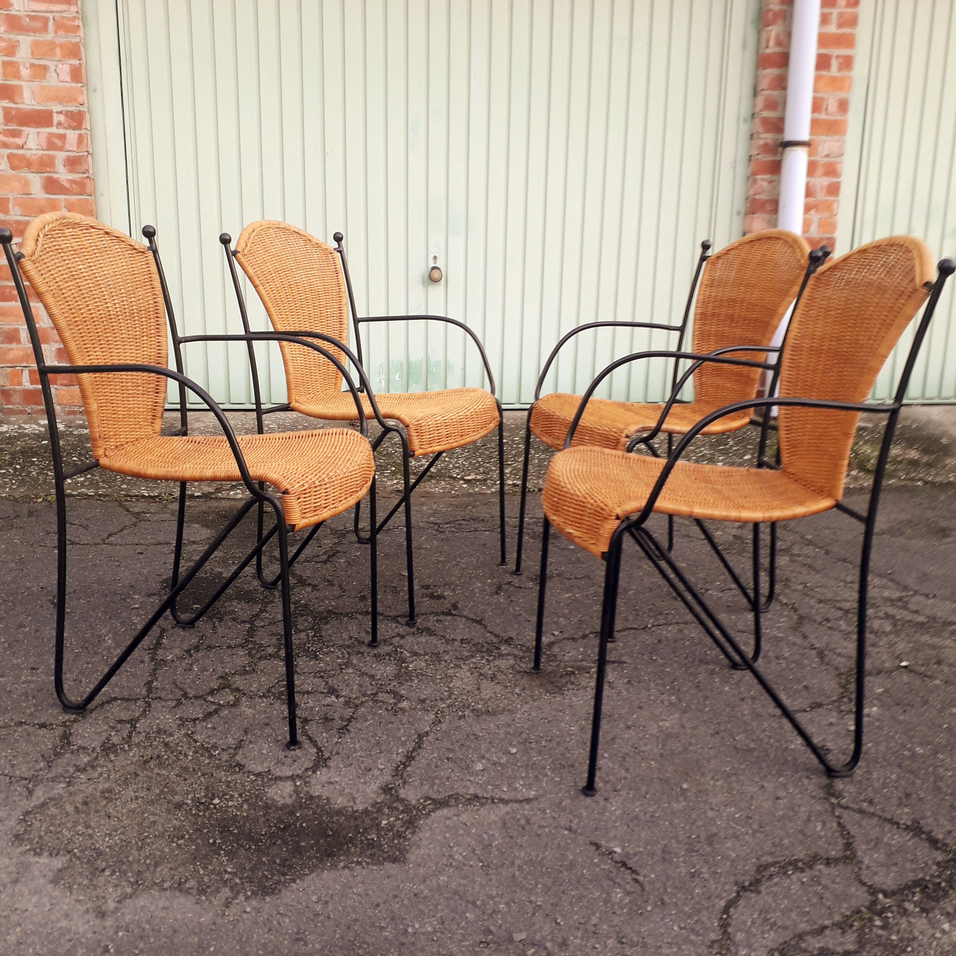4 vintage wrought iron rattan chairs.
