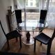 For sale: bevelled glass table and Artedi leather chairs.