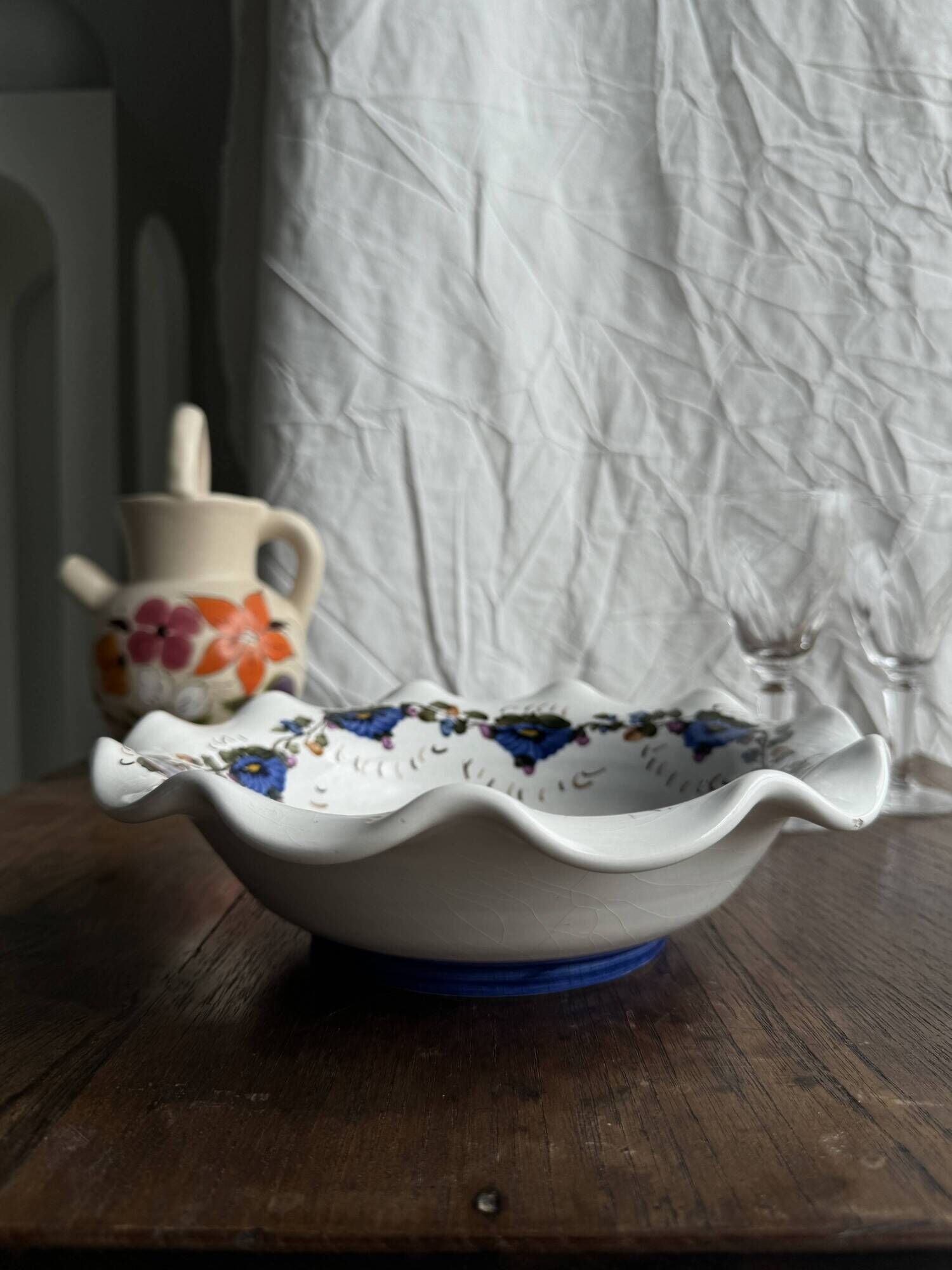 Small hand-painted earthenware salad bowl with garland of blue flowers, mark below