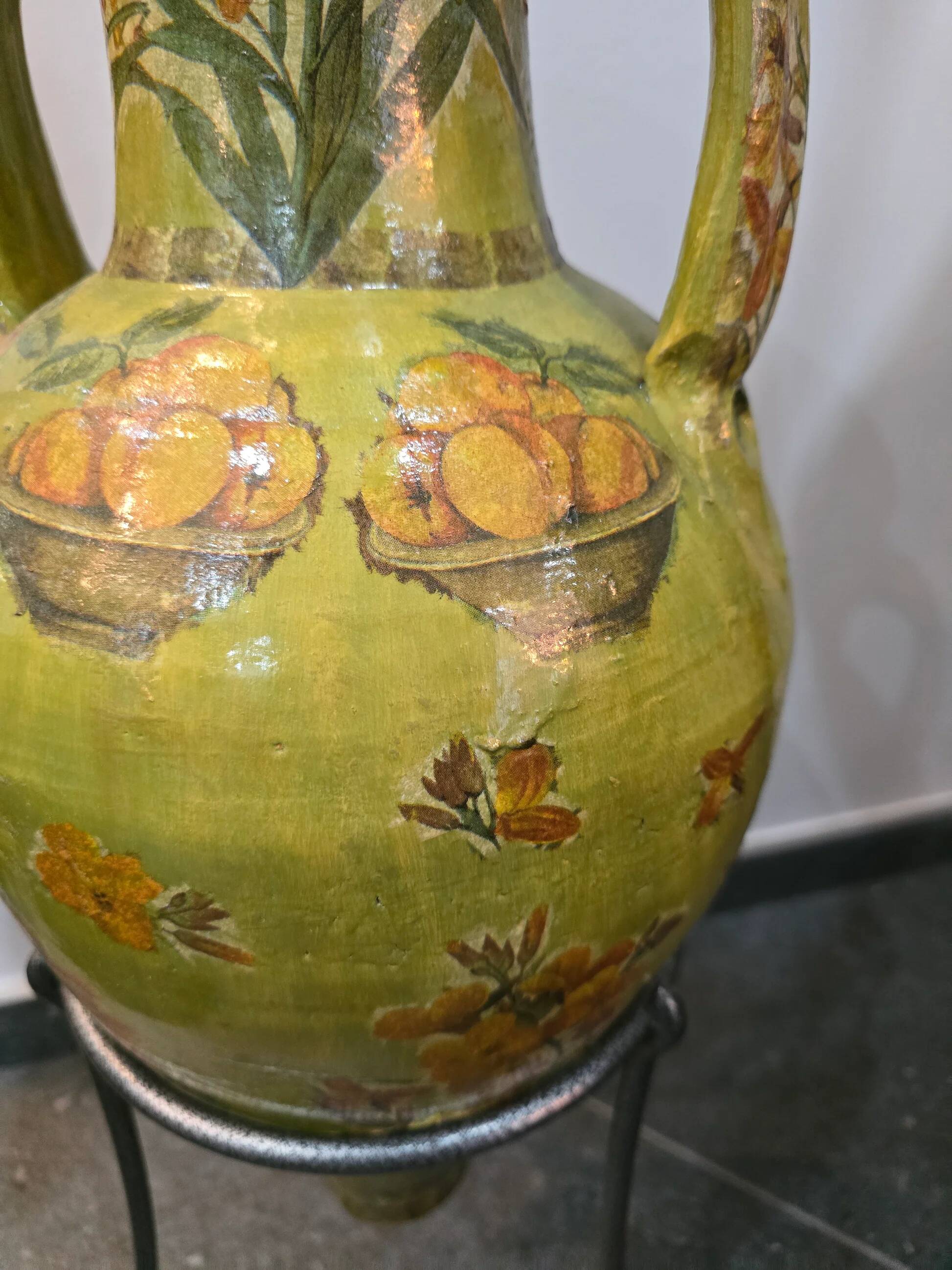 Large decorative vase with handles – painted floral design – on a metal stand