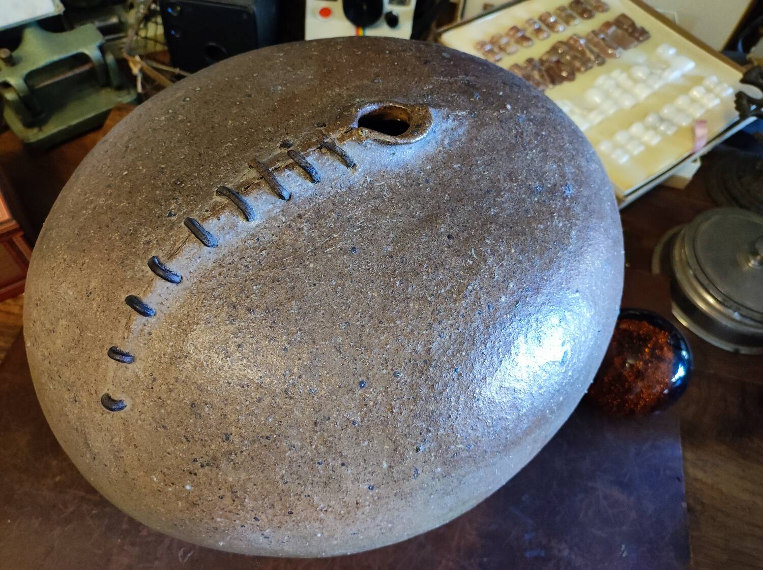 Vintage sandstone vase, in the shape of a rugby ball, signed