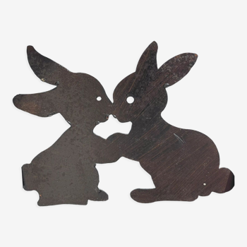 Cast iron plate in the shape of rabbits
