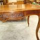 Curved desk in Louis XV style, made of carved and moulded walnut.