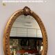 Gold oval mirror refurbished with a pediment — Louis XVI / Napoléon III style