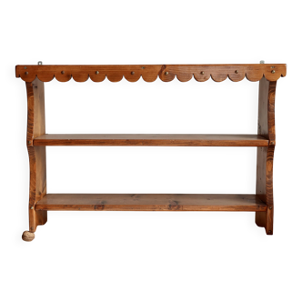 Vintage pine wall shelf with a scalloped front.