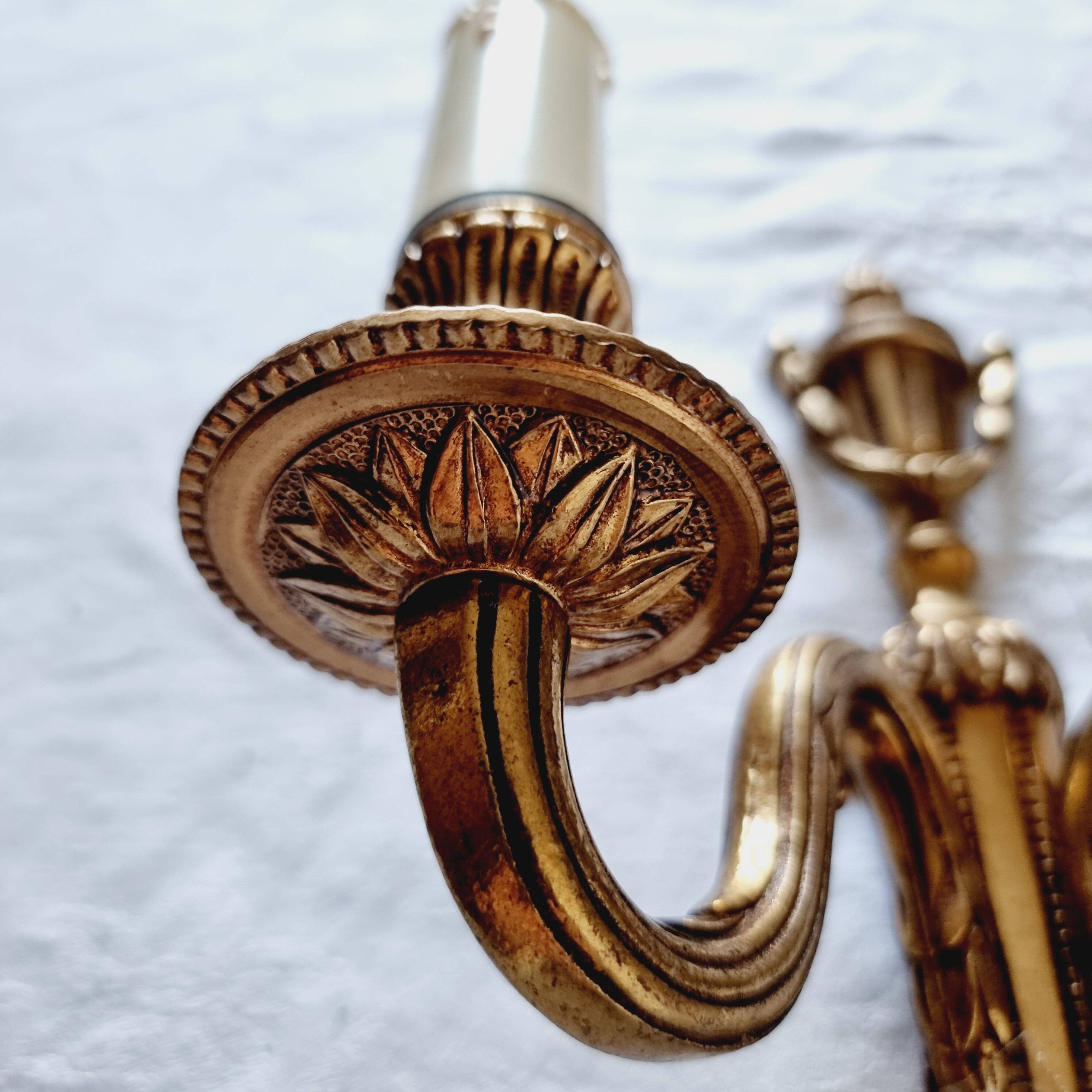 French Empire-style wall sconce or chandelier in bronze with an antique gold patina.