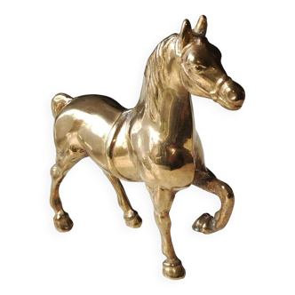 Brass horse sculpture standing still, leg raised. vintage from the 70s.