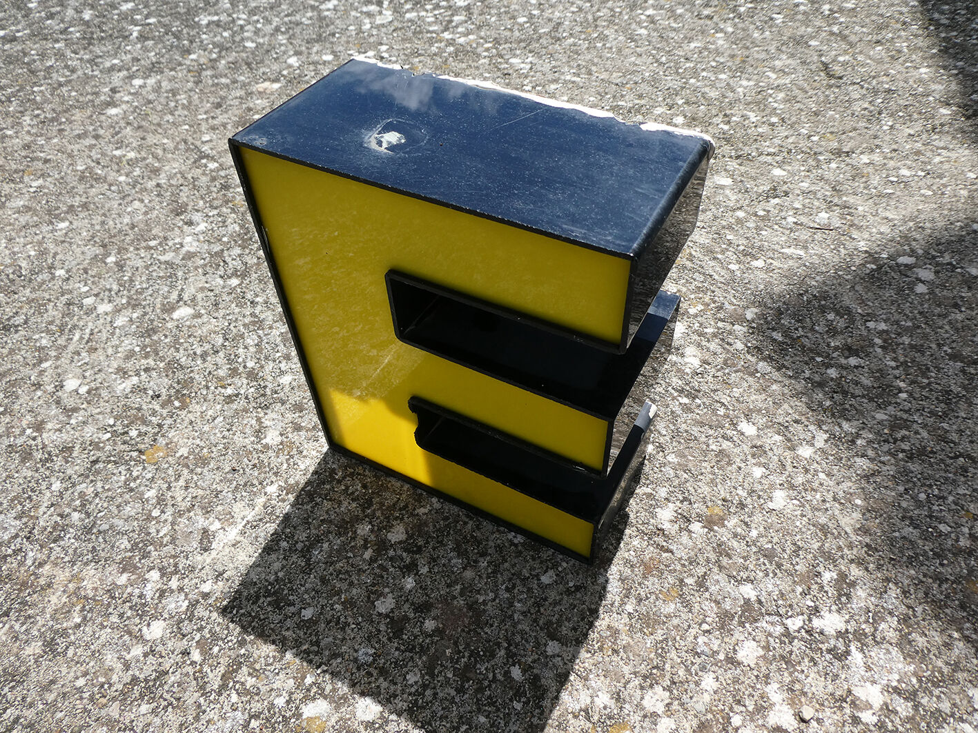 Yellow and black industrial sign letter "E"