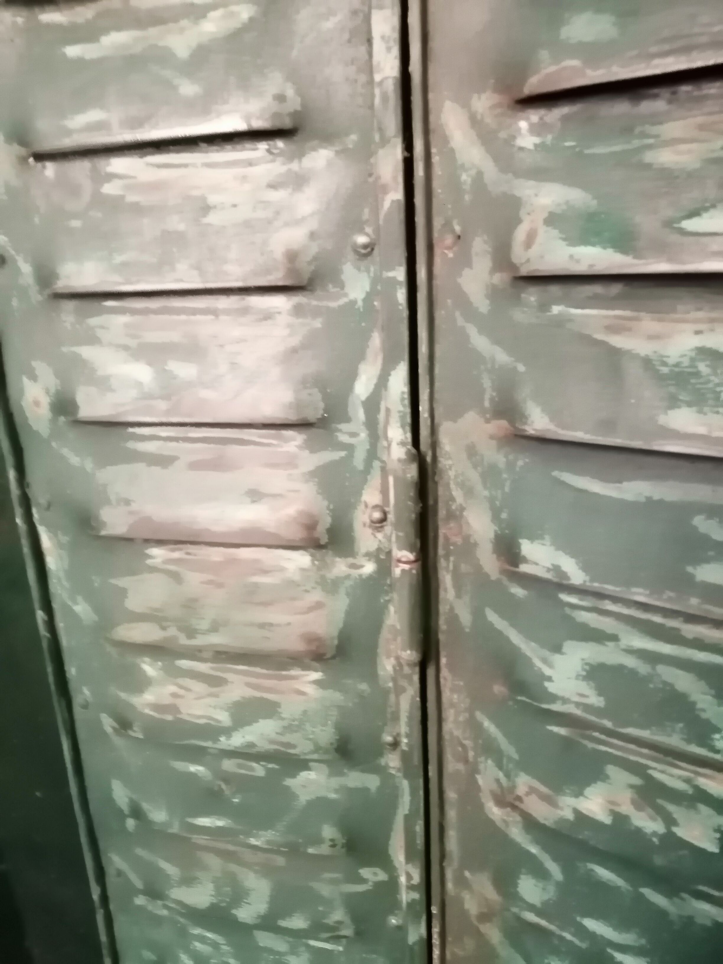 Lot of old green shutters in 4-part iron screen headboard