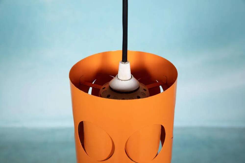 Vintage orange suspension light in a 1970s space age style.