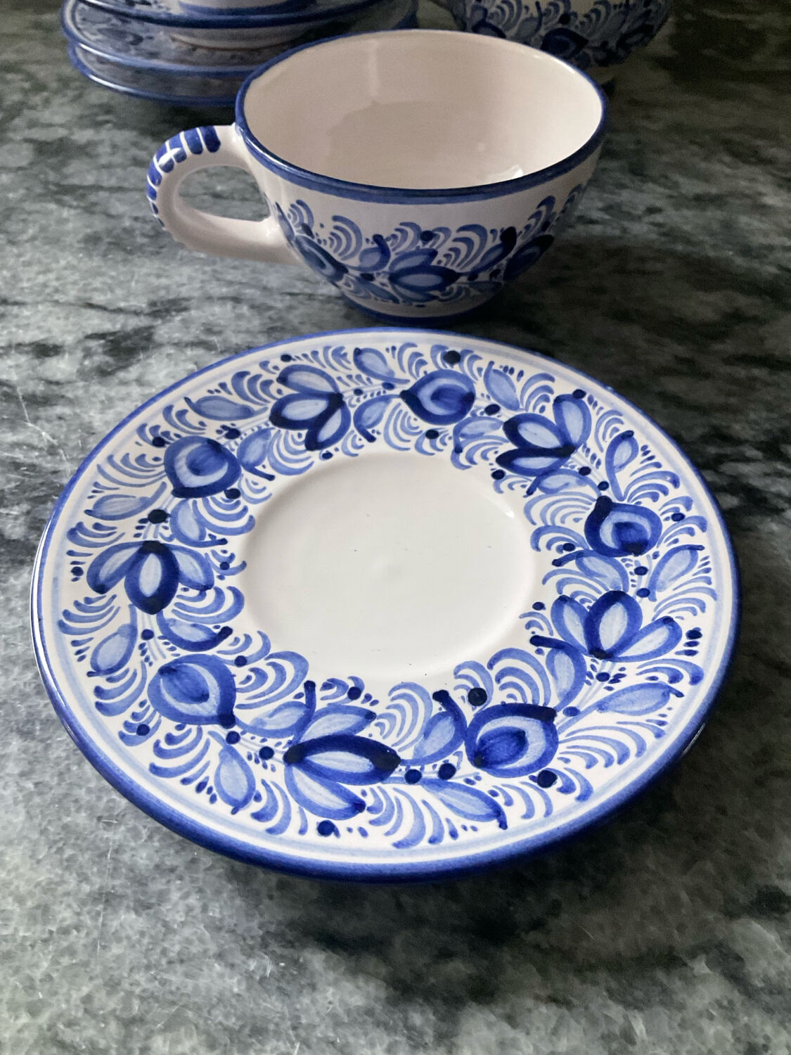 Set of 4 white/blue ceramic cups and saucers.