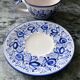 Set of 4 white/blue ceramic cups and saucers.