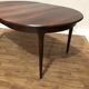 Extendable dining table in Rio rosewood.