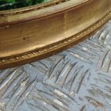 Antique oval mirror in gilded stucco with gold leaf, 19th century