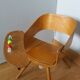 Baumann Baby Coquille children's armchair in bent wood with splayed legs.