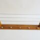Wall coat rack with hat rack made of teak and gold metal,
