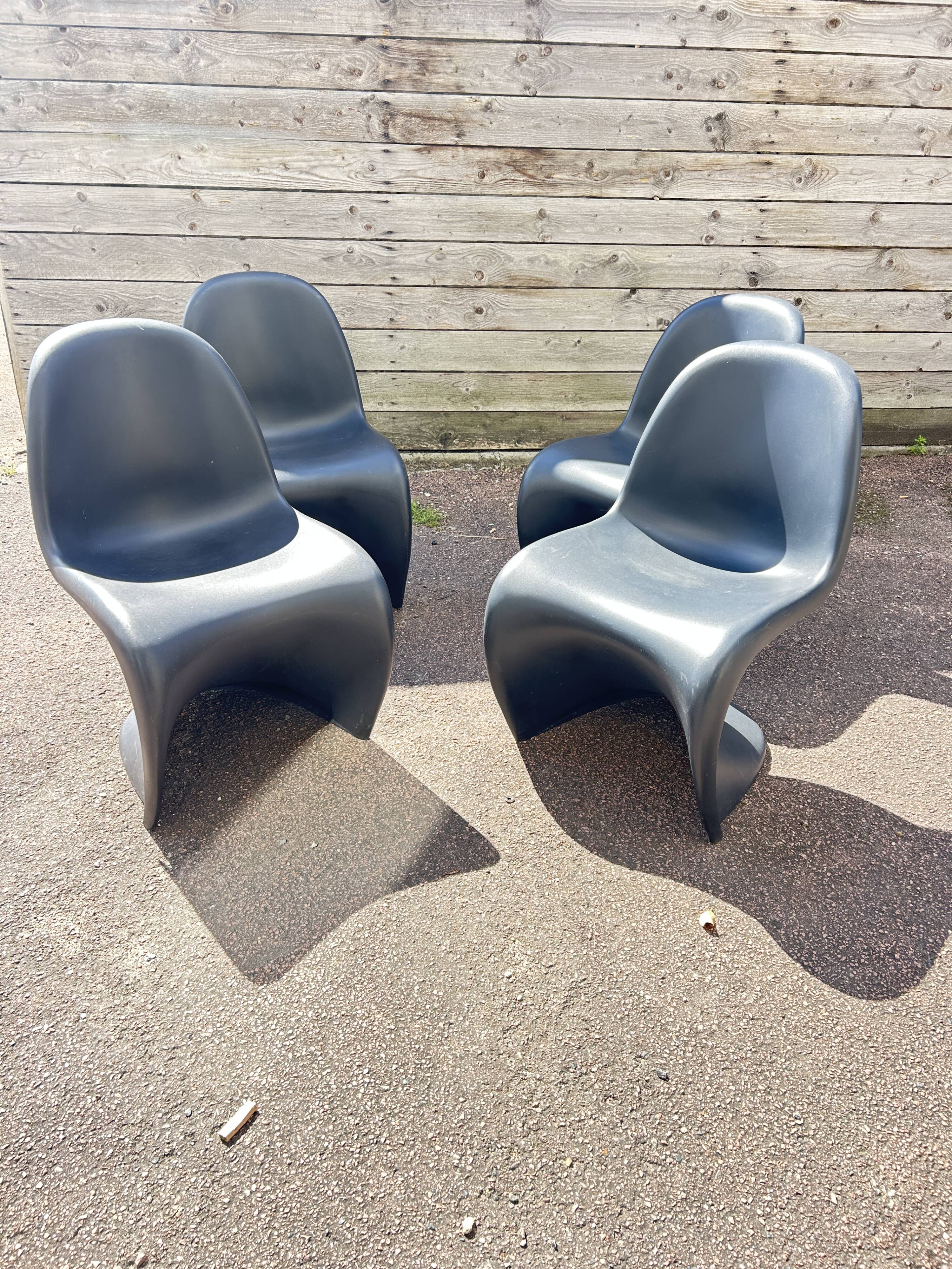 Set of 4 black Verner Panton Vitra chairs.