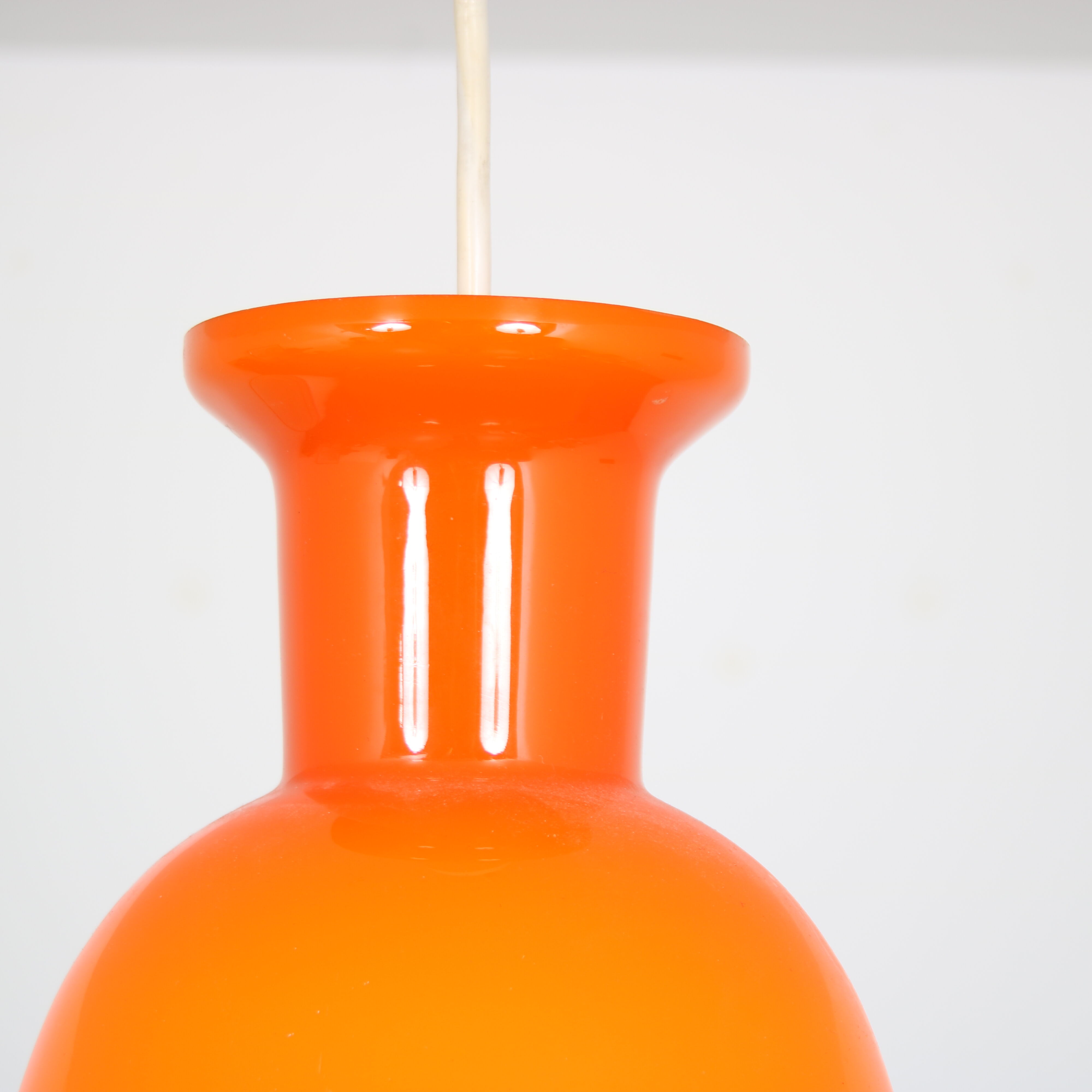Pair of orange hanging lamps by Raak, the Netherlands, 1970