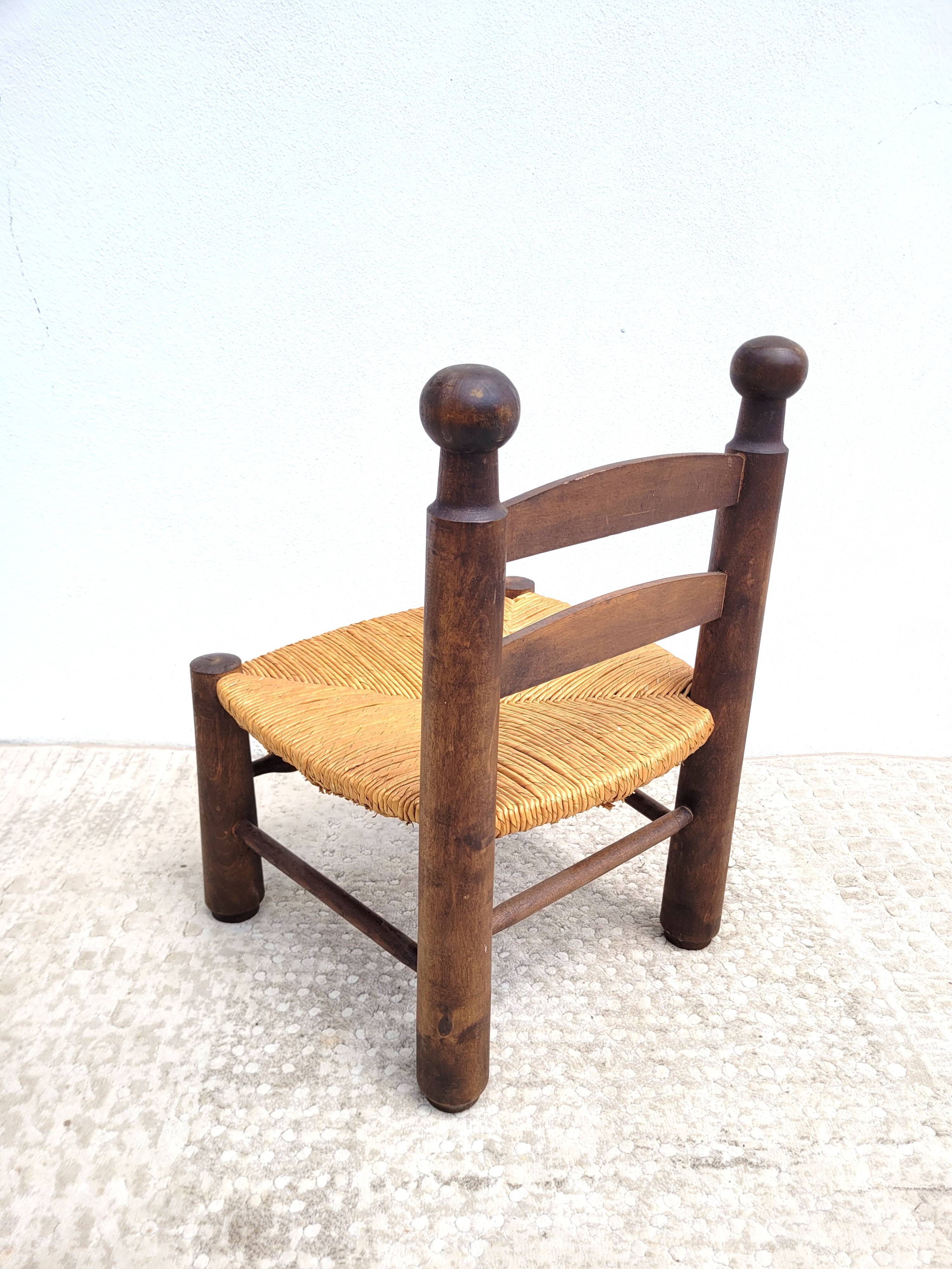 Low chair in turned wood and straw