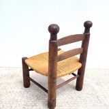 Low chair in turned wood and straw