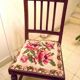 Wooden chair with embroidered seat
