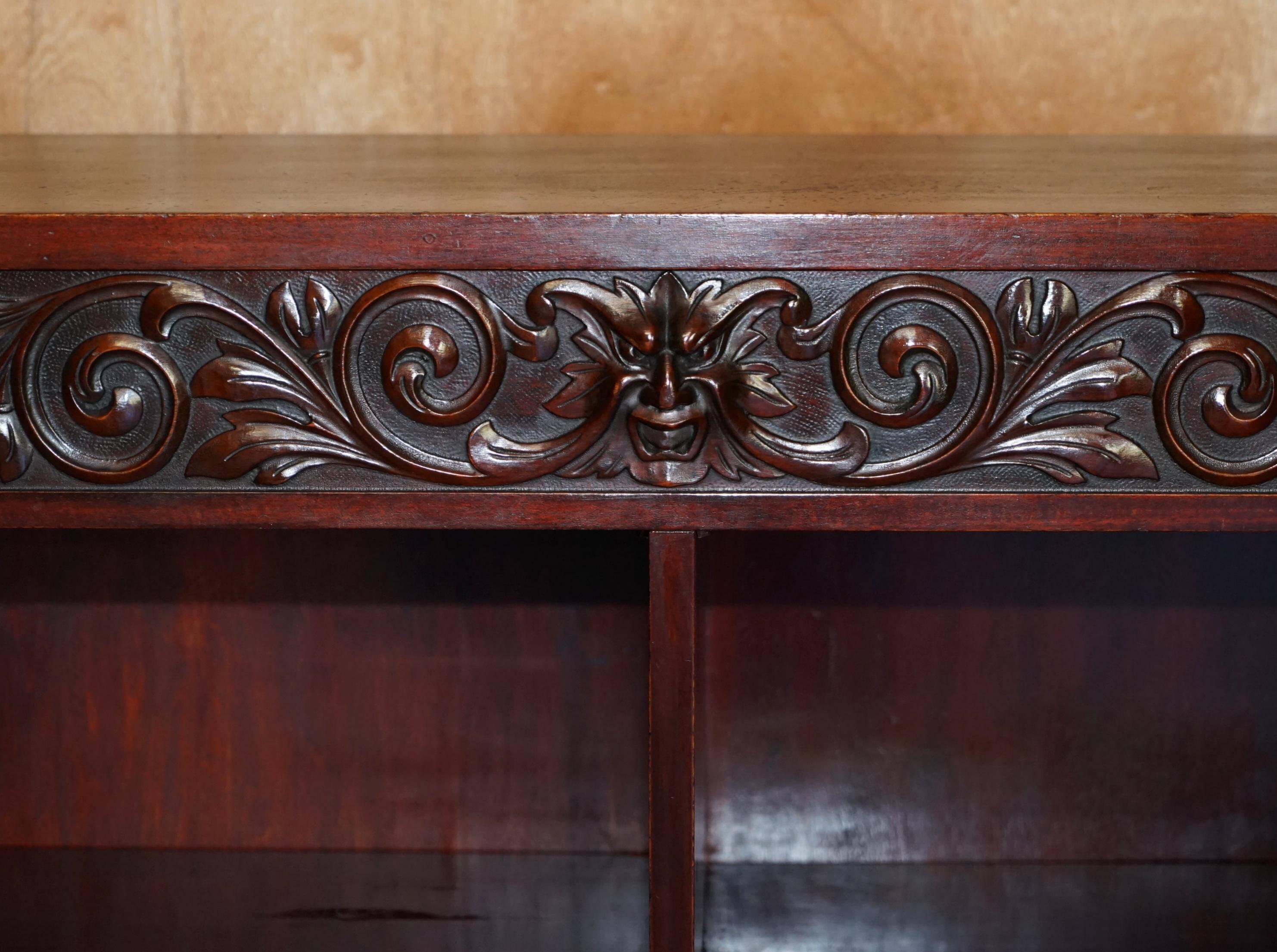 Hand-carved library circa 1900 in hardwood with Hermes statues.