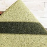 Vintage armchair in moss green bouclé design by H. Lis.