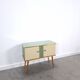 Vintage green DDR cabinet, model Libelle with glass top, slanted legs.