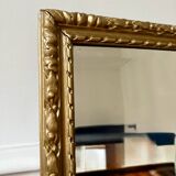 Bevelled mirror in carved gilded wood