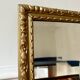 Bevelled mirror in carved gilded wood