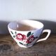 A set of 2 Digoin Sarreguemines cups with pink and blue flowers.