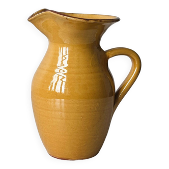 Yellow glazed ceramic pitcher.