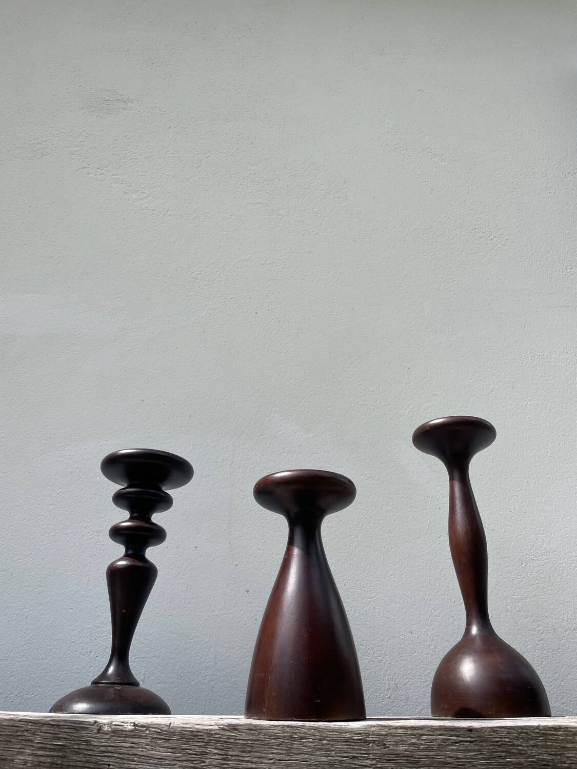 Trio of large turned wooden candlesticks