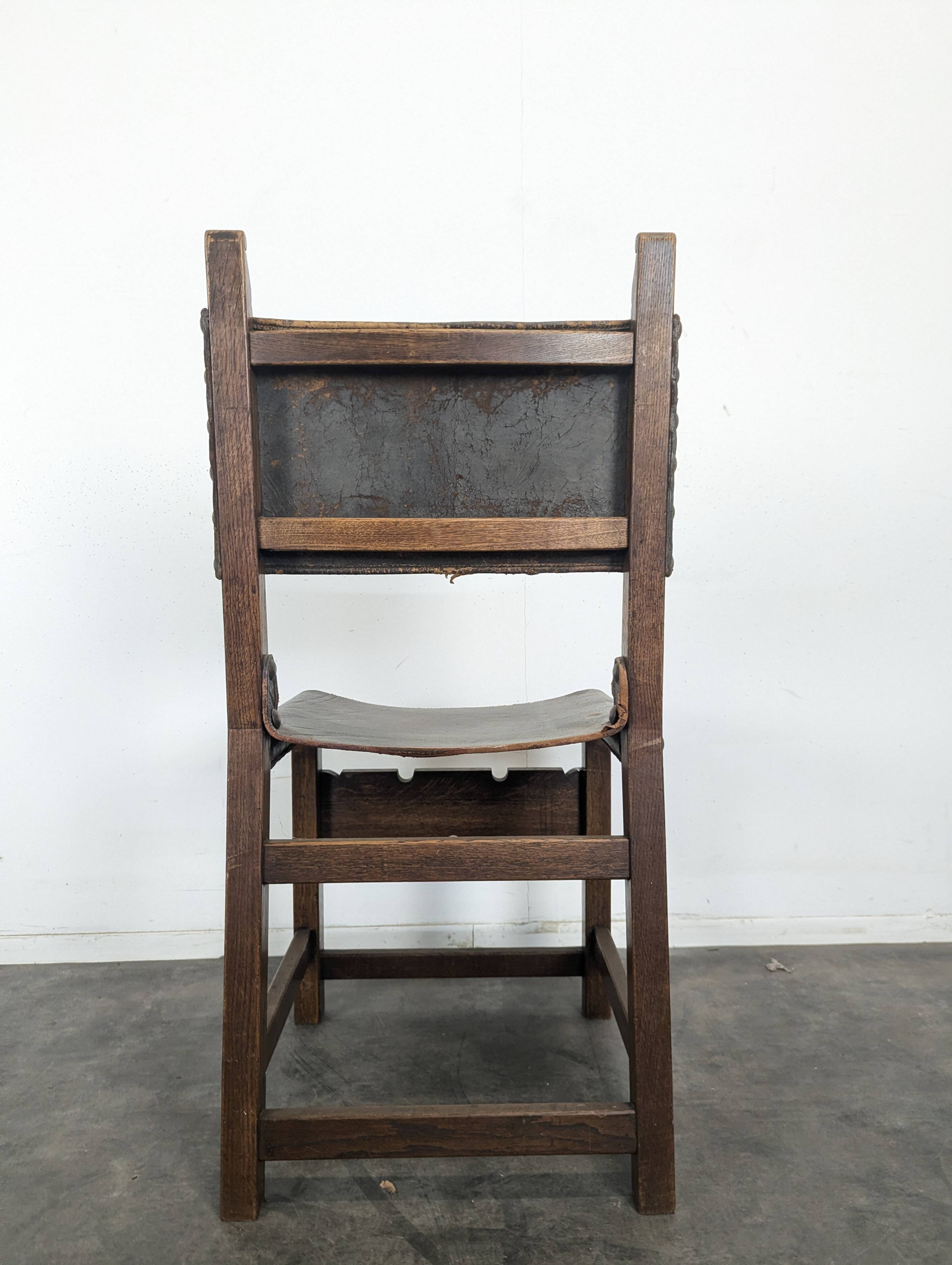 Set of 8 Gothic-style chairs in oak and studded leather.