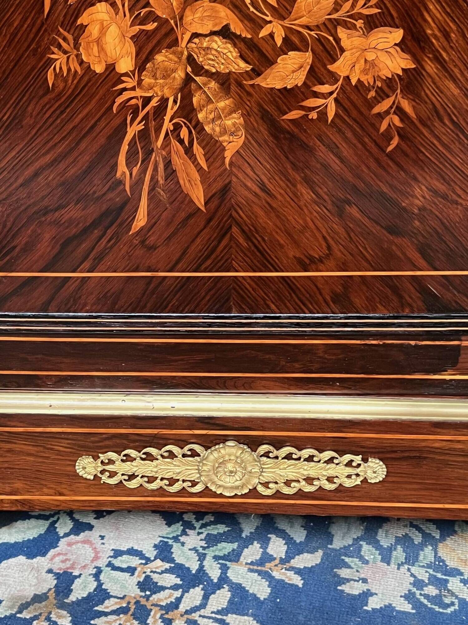 Elegant Napoleon III style commode with fine marquetry, gilded bronze mounts, and a marble top.