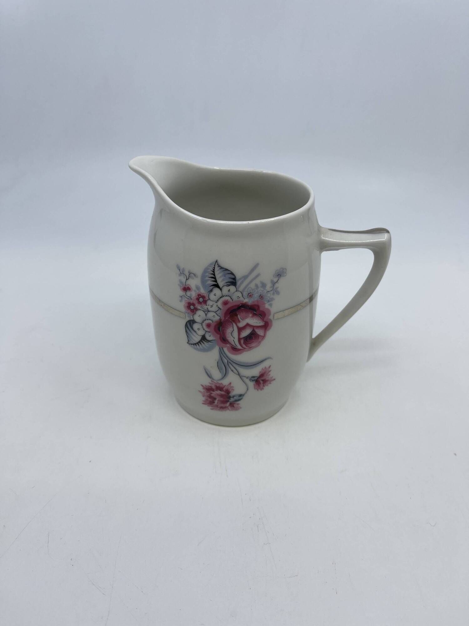 Porcelain coffee service with floral decoration and silver trim.