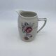 Porcelain coffee service with floral decoration and silver trim.