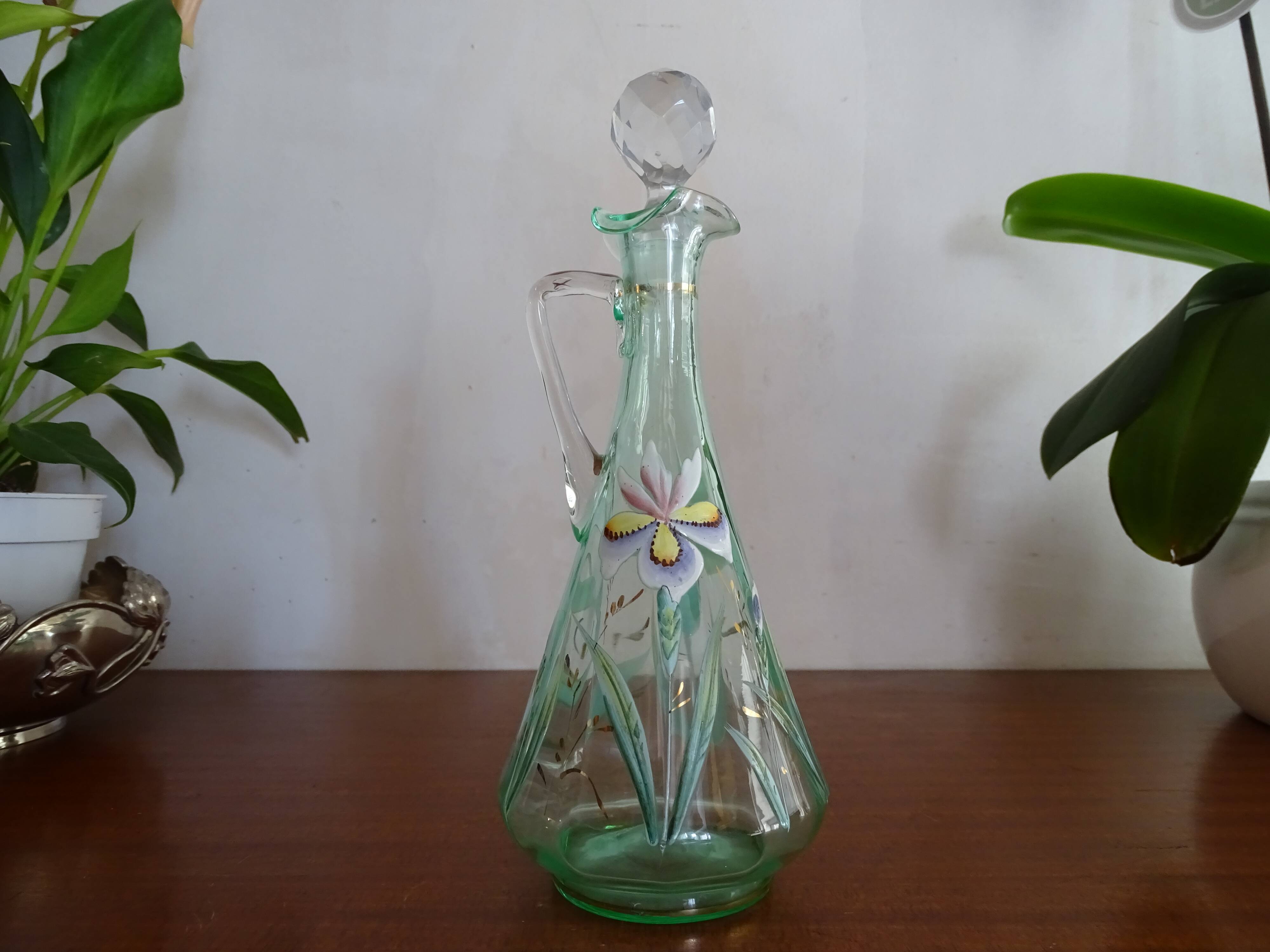 Old carafe enamelled with glass flowers