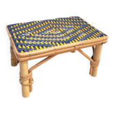 Small side table in yellow and navy blue rattan.