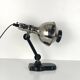 Directional articulated lamp in nickel-plated chrome and black bakelite, with cast iron counterweight.