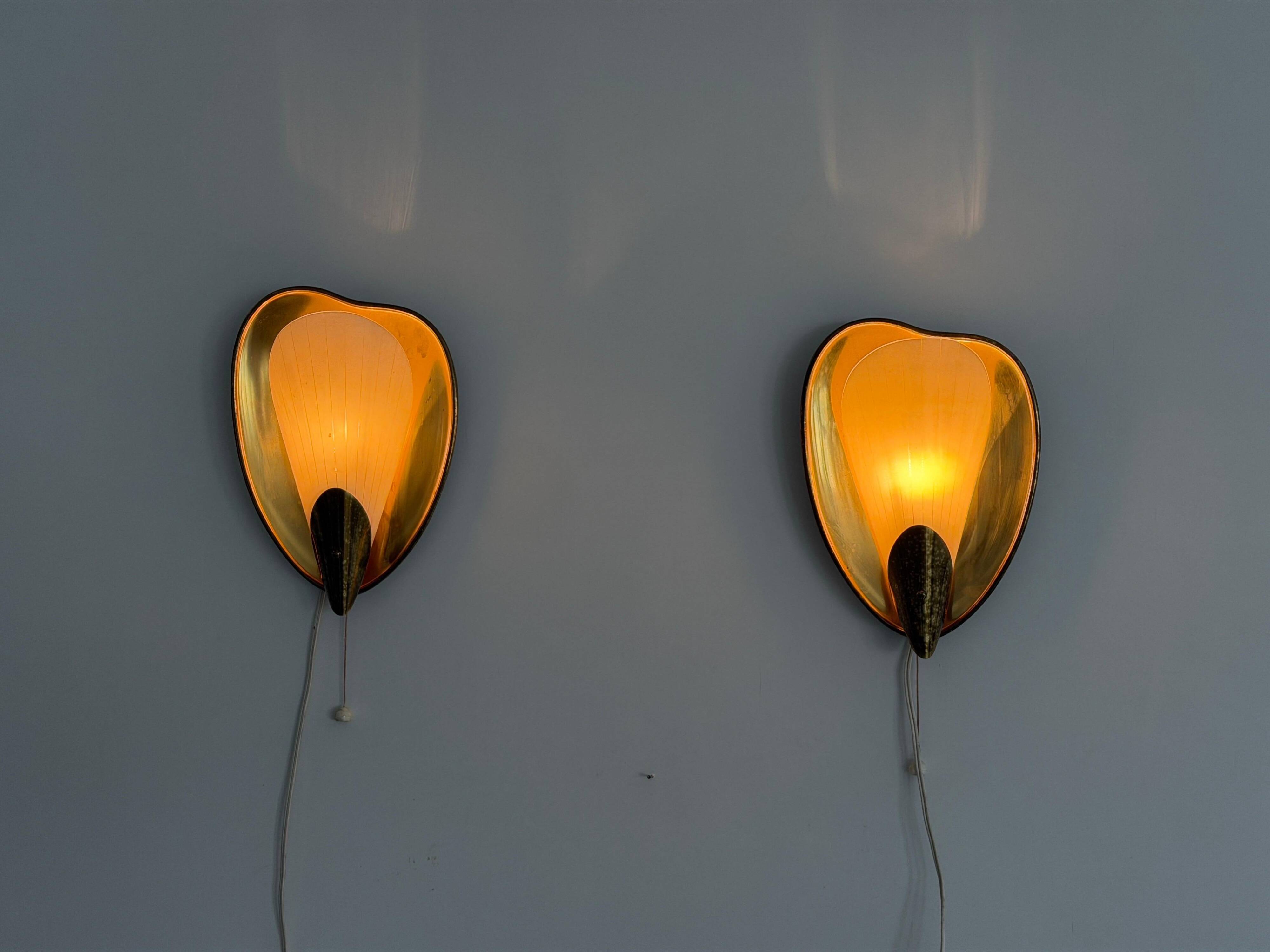 Pair of brass and glass wall lights from the mid-century, 1950s, Germany.