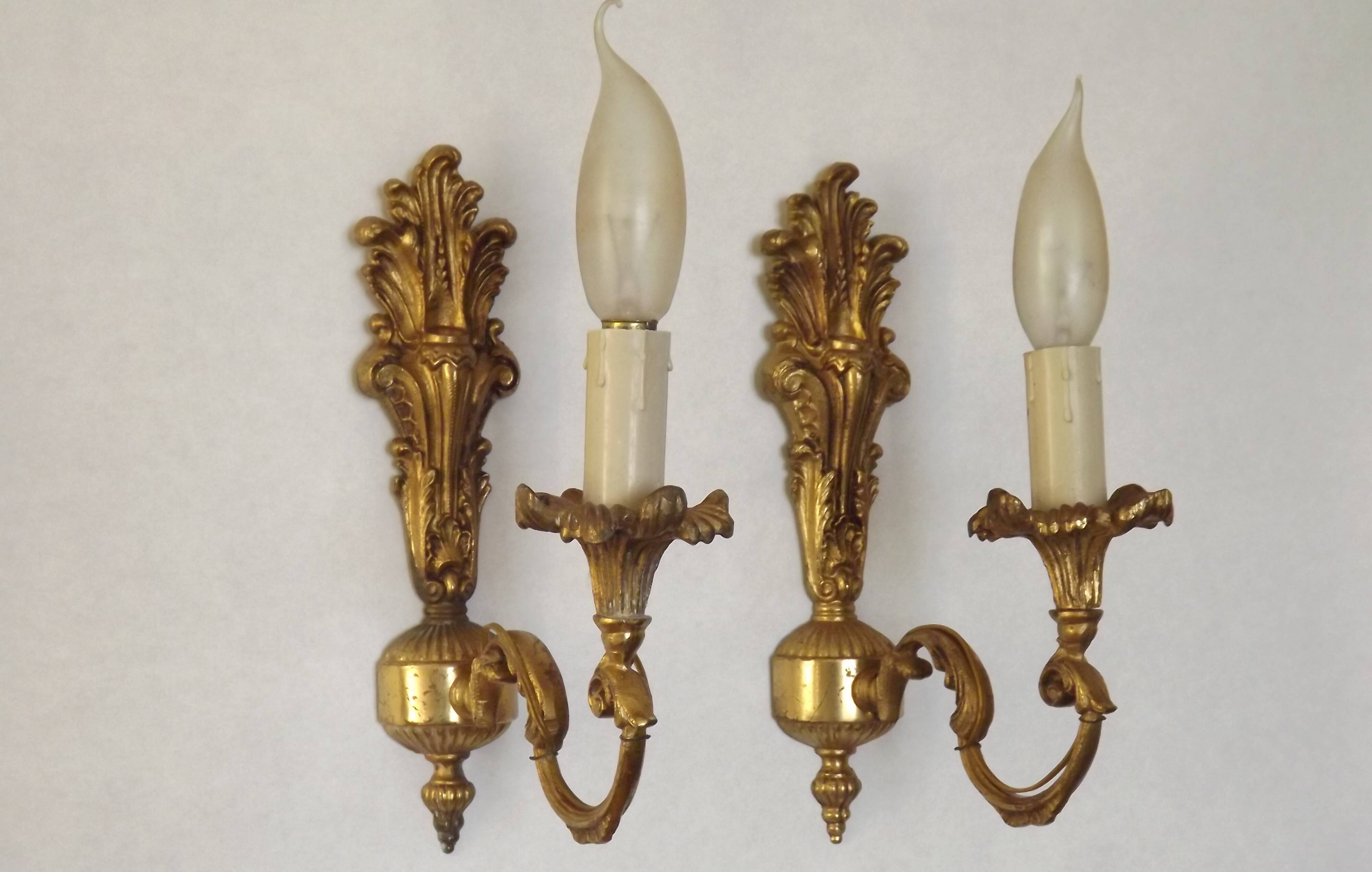 Pair of simple vintage French wall sconces in Art Nouveau bronze with leaf-shaped details.