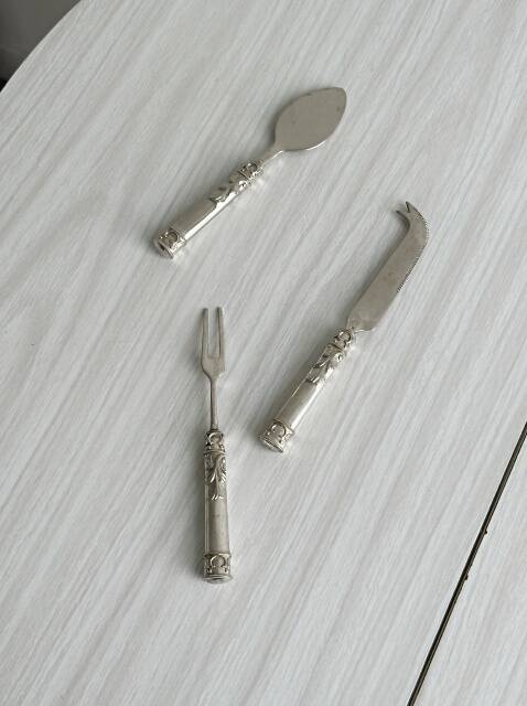 Antique shiny metal cheese cutlery