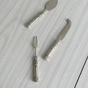 Antique shiny metal cheese cutlery